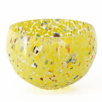Glass bowl, pea green with speckled inclusions, rounded asymmetrical shape, studio lighting, white background, reflective surface.