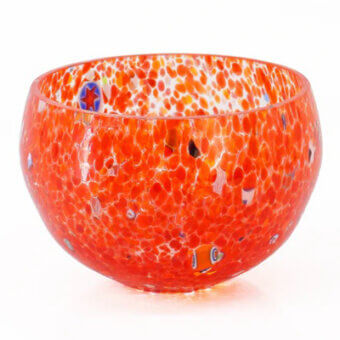 Glass bowl, orange-red with white speckles, rounded shape featuring embedded blue, yellow, and black glass inclusions and fish motifs.
