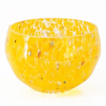 Spotted yellow bowl, translucent material, rounded shape with white and dark speckles against a plain white backdrop.