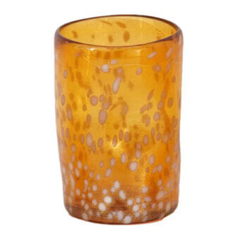 Glass tumbler, amber and gold, cylindrical shape with speckled pattern and hand-blown texture on a white background.