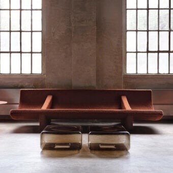 Distinguished Acerbis Trench sofa with a fluid curve and reddish-brown textured matte textile upholstery built with a dark-toned wood base