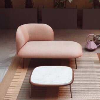 Sophisticated Bross SIT Outdoor chaise lounge in muted coral textured fabric with dark-toned metal frame