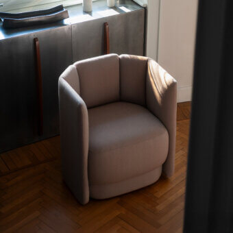 Lavish Bross Velia lounge chair with sculpted form and refined details in textured beige textile upholstery