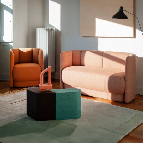 Distinguished Bross Velia sofa with compact form and refined details upholstered in muted coral textile with elegant vertical seams