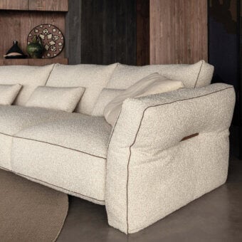 Superior Cierre1972 Loden sectional upholstered in textured creamy beige bouclé fabric with sophisticated leather piping