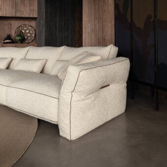 Superior Cierre1972 Loden sofa with inviting low profile, creamy beige bouclé-like textile and elegant leather piping