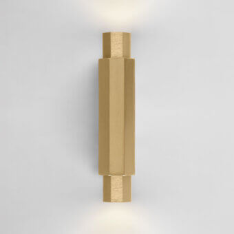 Distinguished Euroluce Castel wall lamp crafted in metal with satin finish, presenting a modern, vertically-oriented form and warm gold tone