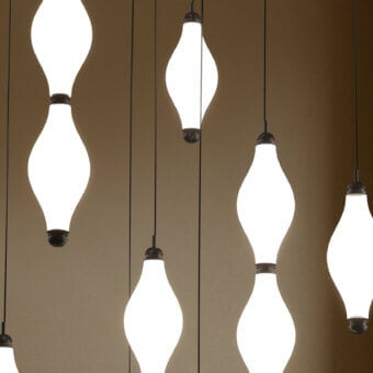 Superior Euroluce Dewy suspension lamp crafted in slightly textured glass with dark matte metal components emitting a warm white glow
