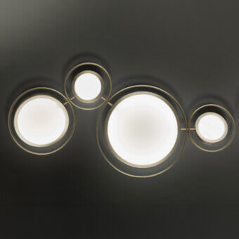 Captivating Euroluce Girasole wall lamp crafted in metal with a satin gold finish and concentric circles radiating warm light
