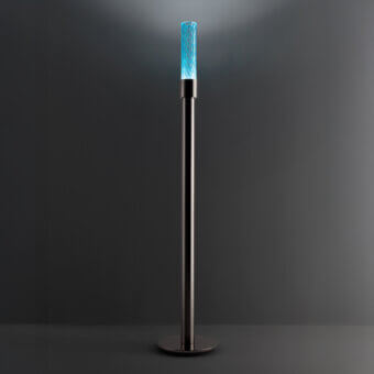 Distinguished Euroluce Gleam floor lamp crafted in muted metal with a textured crystal-like shade emitting vibrant blue light