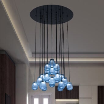 Captivating Euroluce Gocce suspension lamp crafted in translucent blue ribbed glass with a dark matte metal ceiling mount