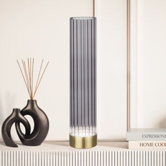 Elegant Euroluce Itala lamp with a ribbed glass body and polished brass-colored metal base offering subtle chromatic contrast