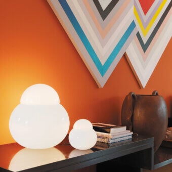 Distinguished FontanaArte Daruma table lamp crafted in overlapping glossy white blown glass with a translucent finish