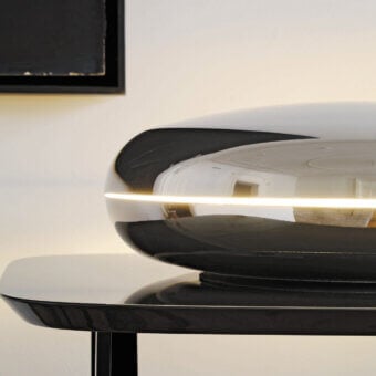 Exceptional FontanaArte Loop table lamp in glossy metal with deep black finish and unique looped form
