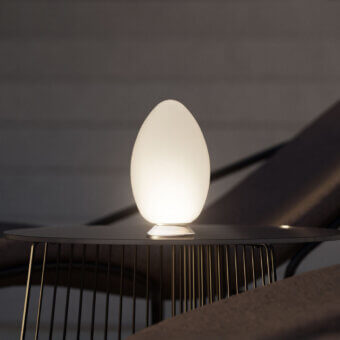 Superior FontanaArte Uovo portable lamp crafted in satin white blown glass embodying a minimalist egg shape