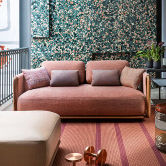Superior Giorgetti Moorea sofa with pewter painted stainless steel and teak, upholstered in muted coral textile with a subtly nubby finish