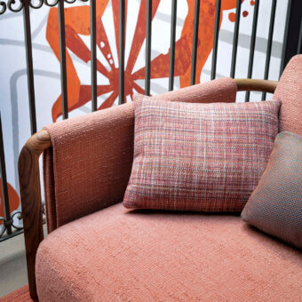 Distinguished Giorgetti Moorea sofa with a pewter painted stainless steel frame and coral-peach textured fabric upholstery