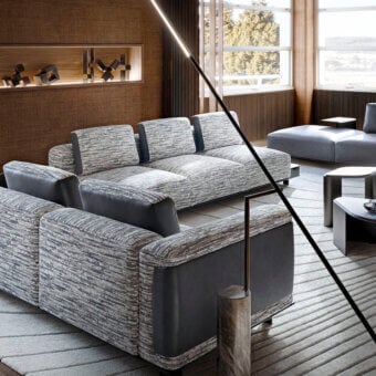 Superior Giorgetti Nereide sectional with muted gray woven textile and dark gray leather accents built on a pewter finished ash wood platform