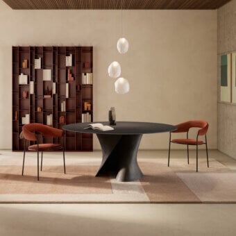 Elegant MDF Italia S table crafted in white concrete with an extra-clear glass top exhibiting dynamic curves
