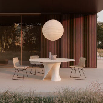 Superior MDF Italia S table outdoor crafted in white concrete with a transparent extra-clear glass tabletop and flowing lines