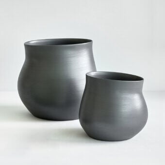 Exceptional Rina Menardi Agape vessel sculpted from baked clay in dark gray with a smooth matte finish