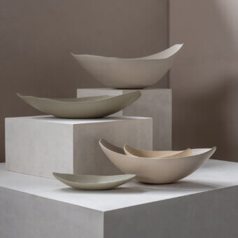 Distinguished Rina Menardi Barchette centerpiece crafted from baked clay with undulating curves and matte finish in beige and pale olive green