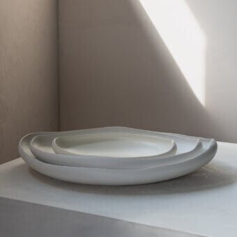 Distinguished Rina Menardi Laguna centerpiece crafted in baked clay with a gently curved asymmetrical silhouette and smooth matte finish