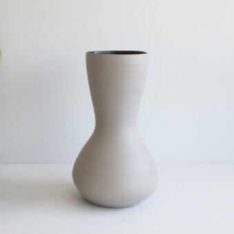Exclusive Rina Menardi Venere & Zeus vase crafted in baked clay with a light gray finish and hourglass silhouette