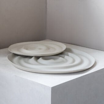 Distinguished Rina Menardi Vortici centerpiece crafted in baked clay with a neutral light gray matte finish