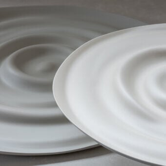 Exclusive Rina Menardi Vortici centerpiece crafted in baked clay with a swirling organic pattern and smooth matte finish
