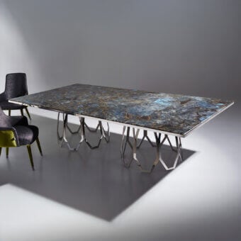Distinguished Sicis Borgia table with dark grey, blue and white marble tabletop and polished metal base built in interconnected angular shapes