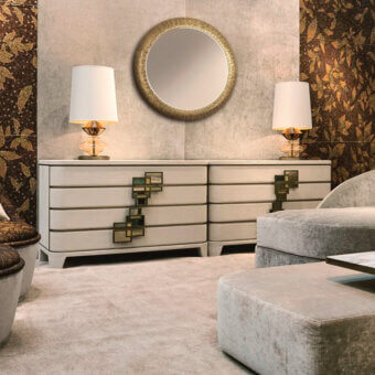 Sicis dresser, cream and brass, six drawers with geometric green and brass panel insets, lamps, mirror, gold wallpaper.