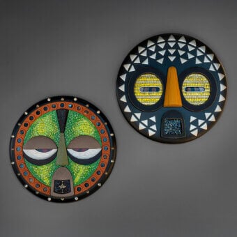 Captivating Sicis Mask Capsule Collection mask with navy blue background and vibrant yellow mosaic face crafted in natural wood and Vetrite glass