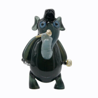 Murano glass sculpture, smoky gray-green, cartoon elephant with blue eyes holding a clear glass pipe and wearing a black hat.