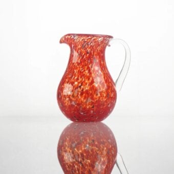 Exceptional Wave Murano Glass Go.To Murano drinking glass and pitcher crafted in reddish-orange with black frit and delicate murrine patterns
