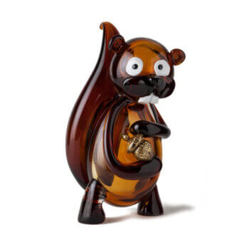 Murano glass squirrel figurine, amber-brown, stylized with blue eyes and white teeth, holding a golden-brown nut against a white backdrop.