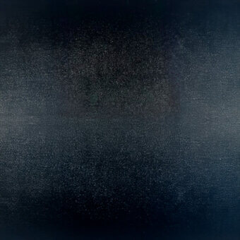 Dark blue-black textured material sample displaying a granular weave pattern, with subtle tonal variations and a code “cf1001 col. 26”.