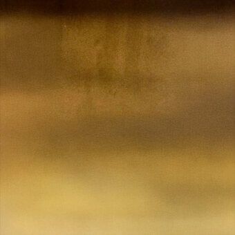 Gradient texture, dark brown to golden yellow, grainy surface with diffused lighting and subtle tonal variations creating a soft, blended effect.