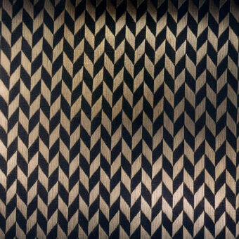 Chevron pattern with alternating navy and beige rectangles, creating angled shapes in a dense, regular composition with a smooth, subtle sheen.