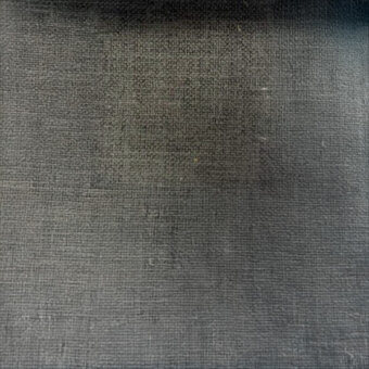 Dark gray woven textile with grid pattern, linen or blend fabric, subtle tonal gradient, visible threads, and studio lighting.