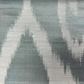 Geometric fabric sample with vertical gray and white bands, woven texture, fragmented pattern, smooth finish for upholstery or drapery.