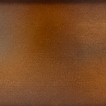Brown coated textile texture with a granular, mottled pattern and matte finish, displaying a gradient from dark to light tones.