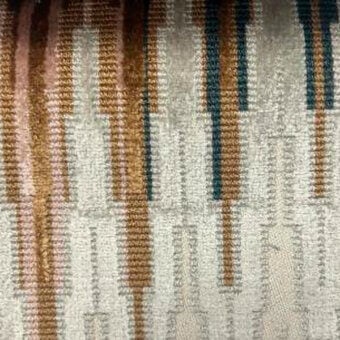 Beige textile sample with vertical stripes in bronze, rust, and teal hues; woven texture with subtle sheen and irregular linear design.