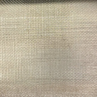 Natural fiber textile with a grid weave, muted beige tones, and a dense, textured surface displaying a regular, matte finish.