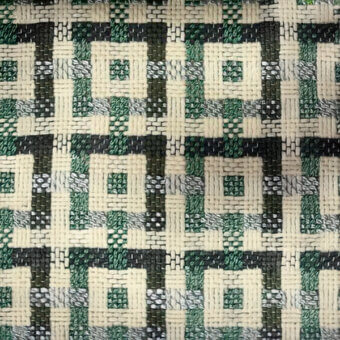 Geometric textile with interlocking squares in off-white, dark green, and gray, featuring a raised, textured weave and subtle repeating patterns.