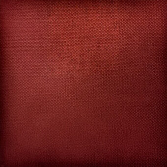 Reddish-brown textured surface with a granular pattern, resembling woven fabric or leatherette, displaying subtle tonal variations and even lighting.