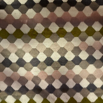 Geometric textile sample with interlocking diamonds in olive, rose, gray, charcoal, and off-white, displaying a woven texture and repeating grid pattern.