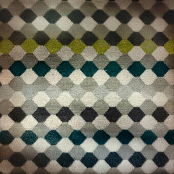 Hexagonal textile pattern in gray, teal, and olive green tones arranged in a diamond grid with a horizontal gradient and woven texture.