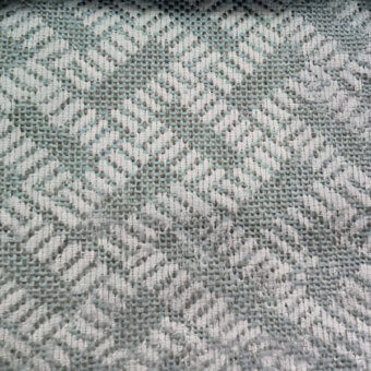 Herringbone textile sample with angled lines in sage green and off-white, featuring a plain weave and nubby texture; labeled "co1008 col.".