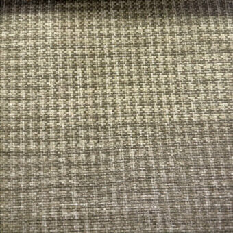 Basketweave fabric sample, muted gray-beige-olive tones, dense textured grid with “co1009 col.” label, matte finish, even lighting.
